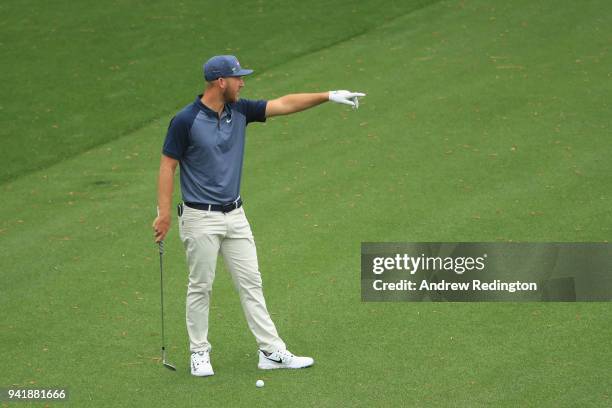 Kevin Chappell of the United States points on the 16th hole during a practice round prior to the start of the 2018 Masters Tournament at Augusta...