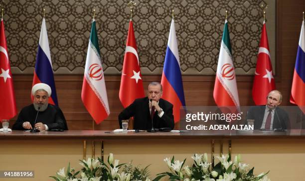 Iran's President Hassan Rouhani, Turkey's President Recep Tayyip Erdogan and Russia's President Vladimir Putin hold a joint press conference during a...