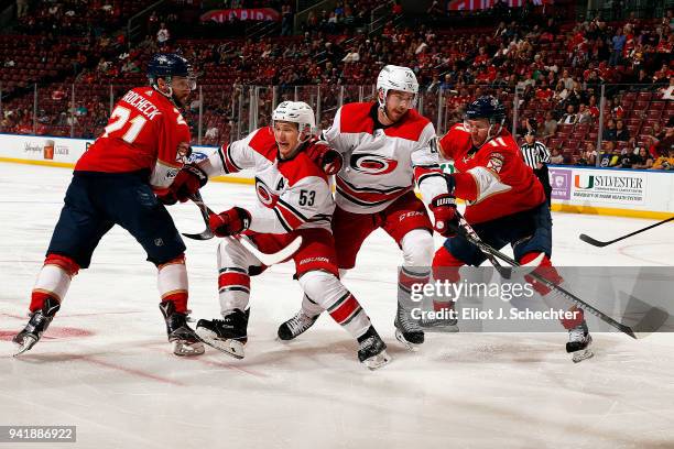 Jeff Skinner and Elias Lindholm of the Carolina Hurricanes tangle with Vincent Trocheck and Jonathan Huberdeau of the Florida Panthers at the BB&T...