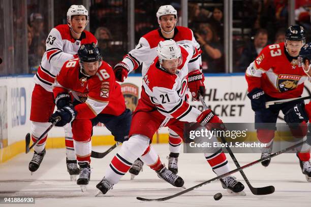 Lee Stempniak of the Carolina Hurricanes skates with the puck against Aleksander Barkov of the Florida Panthers at the BB&T Center on April 2, 2018...