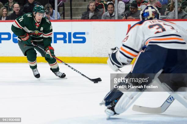 Zach Parise of the Minnesota Wild controls the puck as Cam Talbot of the Edmonton Oilers defends the net during the game on April 2, 2018 at Xcel...