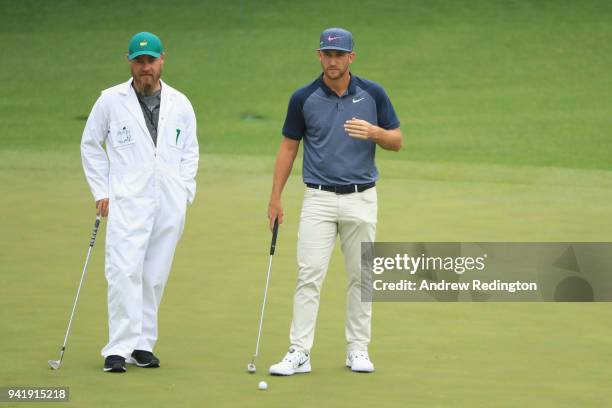 Kevin Chappell of the United States talks with his caddie Joe Grenier during a practice round prior to the start of the 2018 Masters Tournament at...