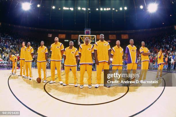 Kobe Bryant, Shaquille O'Neal # and Byron Scott of the Los Angeles Lakers stand for the national anthem before the game against the Orlando Magic at...