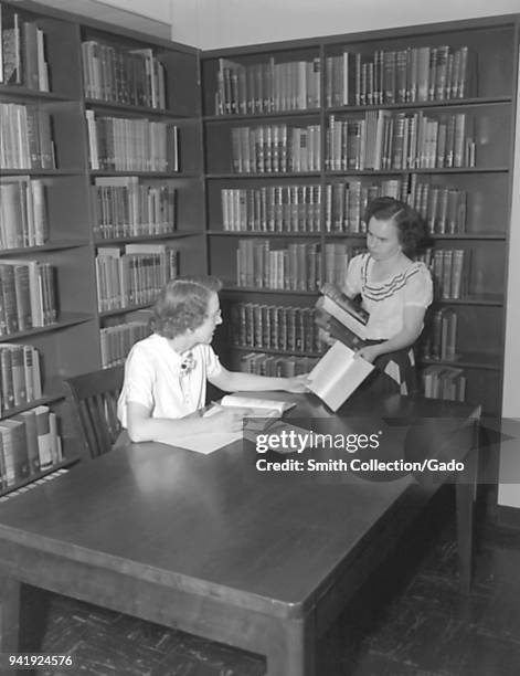Two Centers for Disease Control employees working in the campus library, Chamblee, Georgia, 1952. Image courtesy Centers for Disease Control .