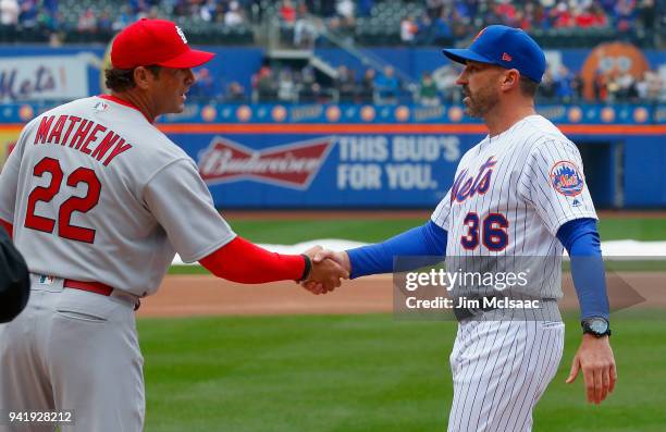 Managers Mickey Callaway of the New York Mets and Mike Matheny of the St. Louis Cardinals meet prior to their Opening Day game at Citi Field on March...
