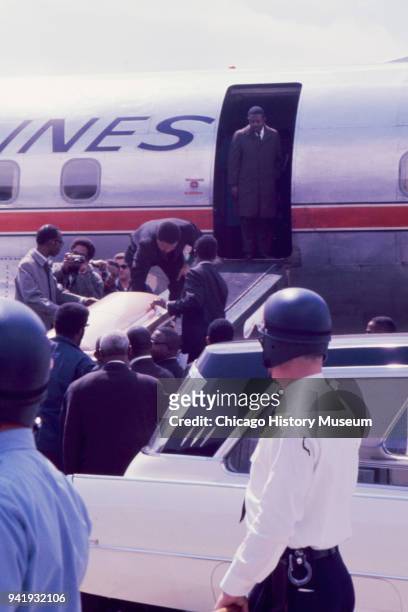Group of men move the late Dr Martin Luther King Jr's casket from a hearse and up the loading ramp of an American Airlines plane on the tarmac at...