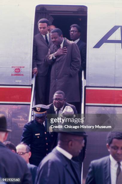 Civil Rights leaders Andrew Young and Reverend Ralph Abernathy , along with others, stand in the open doorway of an American Airlines plane on the...