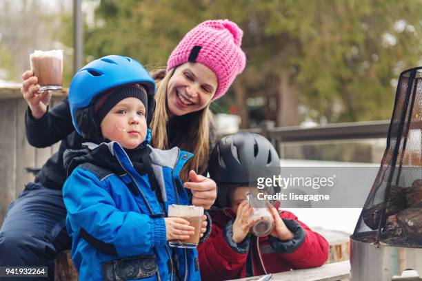 families and friends in a ski resort - hot chocolate stock pictures, royalty-free photos & images