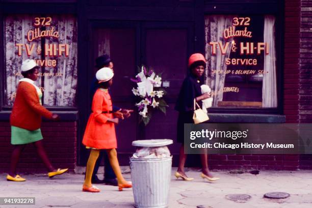 Group of mourners walk past a television repair shop on Edgewood Avenue, Atlanta, Georgia, April 9, 1968. The business was near Ebenezer Baptist...