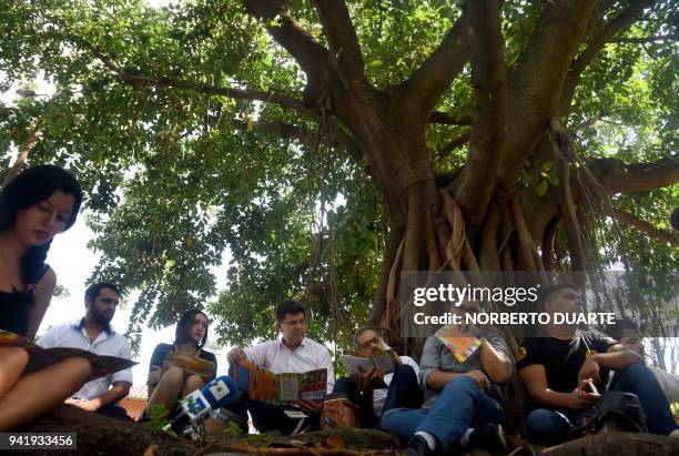 Paraguayan presidential candidate for the National Alliance party, Efrain Alegre and his running mate Leo Rubin share a round of mate with youths of...