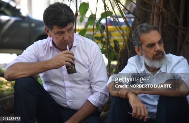 Paraguayan presidential candidate for the National Alliance party, Efrain Alegre and his running mate Leo Rubin share a round of mate with youths of...