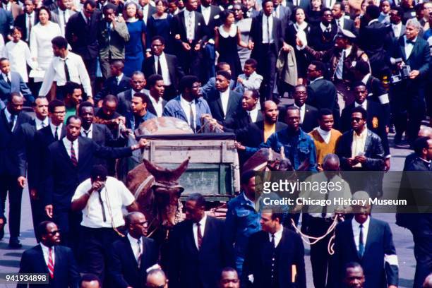 Among the mourners, a mule-drawn wagon carries Dr Martin Luther King Jr's casket during his funeral procession, Atlanta, Georgia, April 9, 1968. The...