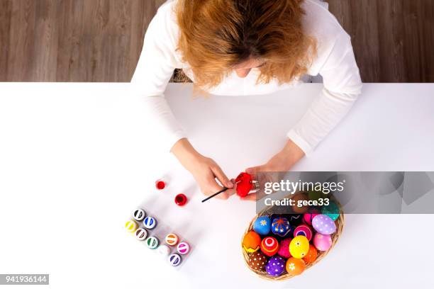 woman is painting egg - decoupage stock pictures, royalty-free photos & images