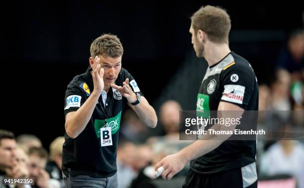 Coach Christian Prokop of Germany speaks to Steffen Weinhold during the handball international friendly match between Germany and Serbia at Arena...
