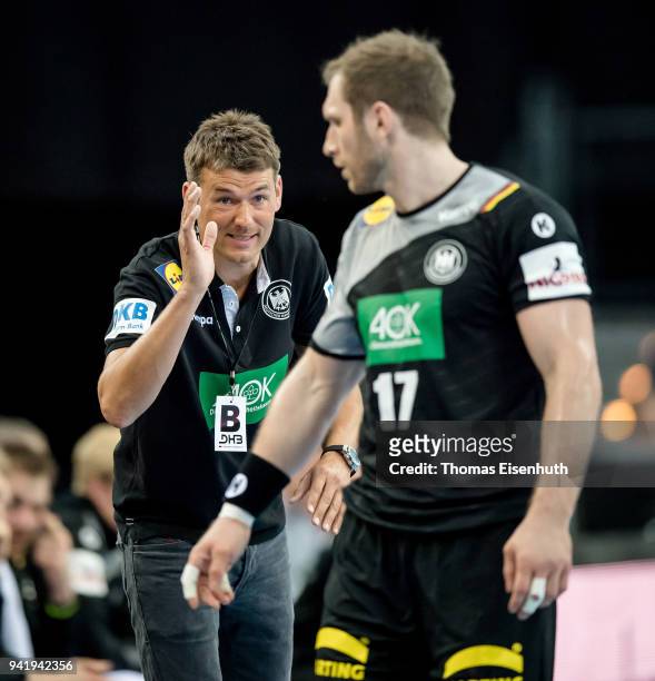 Coach Christian Prokop of Germany speaks to Steffen Weinhold during the handball international friendly match between Germany and Serbia at Arena...