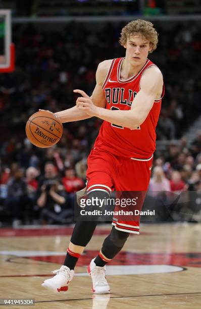 Lauri Markkanen of the Chicago Bulls brings the ball up the court against the Charlotte Hornets at the United Center on April 3, 2018 in Chicago,...