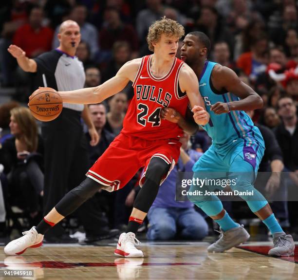 Lauri Markkanen of the Chicago Bulls moves against Michael Kidd-Gilchrist of the Charlotte Hornets at the United Center on April 3, 2018 in Chicago,...