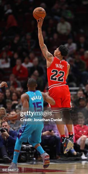 Cameron Payne of the Chicago Bulls shoots over Kemba Walker of the Charlotte Hornets at the United Center on April 3, 2018 in Chicago, Illinois. NOTE...