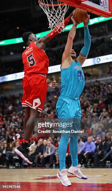 Bobby Portis of the Chicago Bulls blocks a shot by Willy Hernangomez of the Charlotte Hornets at the United Center on April 3, 2018 in Chicago,...