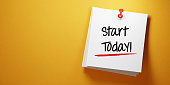 White Sticky Note with Start Today Message And Red Push Pin On Yellow Background
