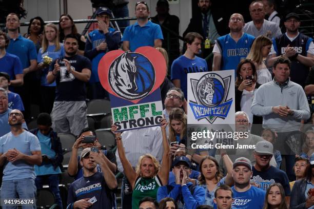 Fans hold signs during the game between the Minnesota Timberwolves and Dallas Mavericks on March 30, 2018 at the American Airlines Center in Dallas,...