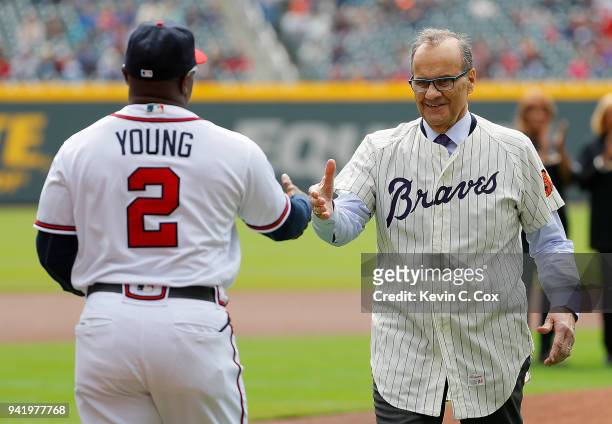 Joe Torre, MLB's Chief Baseball Officer and former member of the Atlanta Braves hugs Eric Young of the Atlanta Braves after throwing out the...