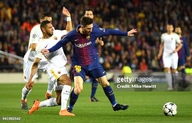 Lionel Messi of Barcelona is challenged by Bruno Peres of AS Roma during the UEFA Champions League Quarter Final Leg One match between FC Barcelona...