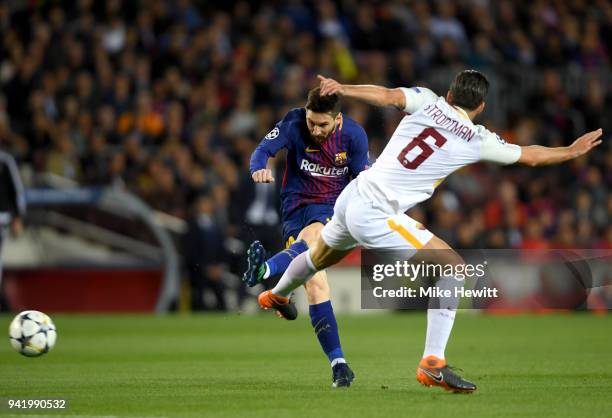 Lionel Messi of Barcelona shoots while under pressure from Kevin Strootman of AS Roma during the UEFA Champions League Quarter Final Leg One match...