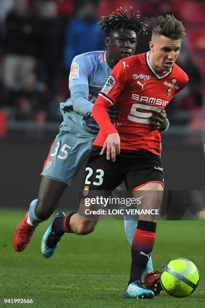 Monaco's French defender Kevin N'Doram tackles Rennes' French midfielder Adrien Hunou during the French L1 football match Rennes vs Monaco at the...