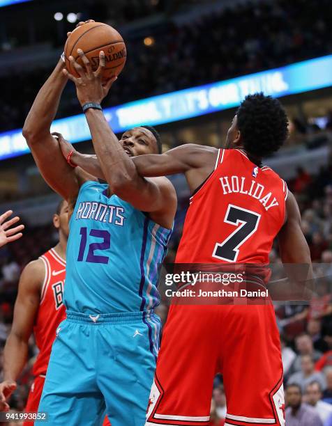 Justin Holiday of the Chicago Bulls fouls Dwight Howard of the Charlotte Hornets at the United Center on April 3, 2018 in Chicago, Illinois. The...
