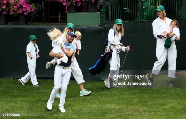 Wesley Bryan of the United States laughs with a guest during the Par 3 Contest prior to the start of the 2018 Masters Tournament at Augusta National...