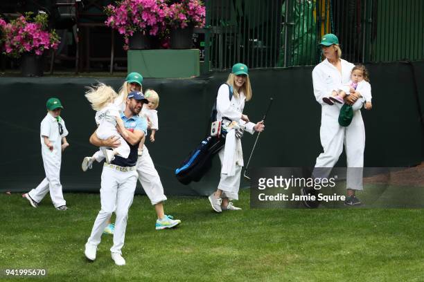 Wesley Bryan of the United States laughs with a guest during the Par 3 Contest prior to the start of the 2018 Masters Tournament at Augusta National...