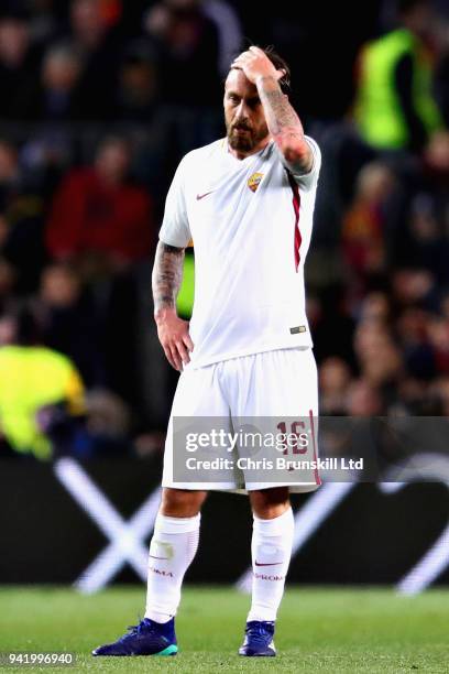 Daniele De Rossi of AS Roma reacts after scoring an own goal during the UEFA Champions League Quarter Final first leg match between FC Barcelona and...