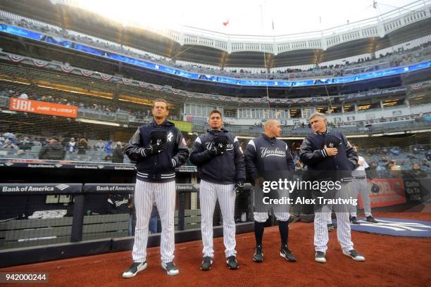 Manager Aaron Boone, infield instructor Carlos Mendoza, first base coach Reggie Willits, and third base coach Phil Nevin of the New York Yankees...