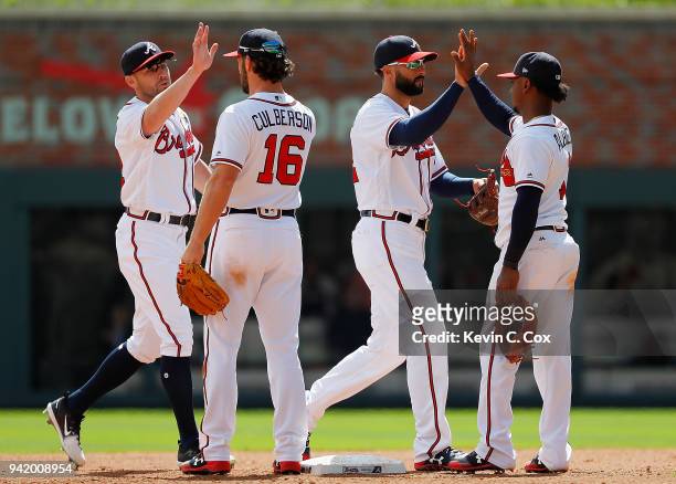 Peter Bourjos, Charlie Culberson, Nick Markakis and Ozzie Albies of the Atlanta Braves celebrate their 7-1 win over the Washington Nationals at...