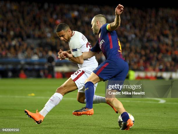 Andres Iniesta of Barcelona is challenged by Bruno Peres of AS Roma during the UEFA Champions League Quarter Final Leg One match between FC Barcelona...