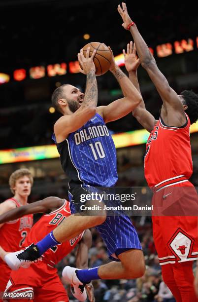 Evan Fournier of the Orlando Magic goes up against Justin Holiday of the Chicago Bulls at the United Center on February 12, 2018 in Chicago,...
