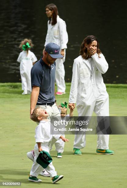 Kevin Chappell of the United States is seen on a green with his wife Elizabeth, son Wyatt and daughter Collins during the Par 3 Contest prior to the...