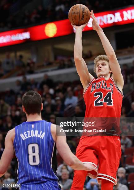 Lauri Markkanen of the Chicago Bulls shoots over Mario Hezonja of the Orlando Magic at the United Center on February 12, 2018 in Chicago, Illinois....