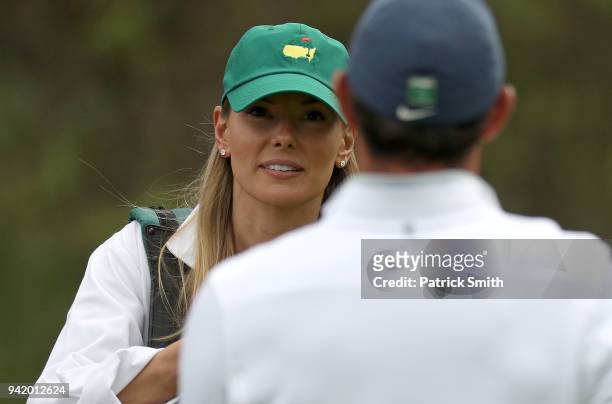 Erica Stoll, wife of Rory McIlroy of Northern Ireland, looks on during the Par 3 Contest prior to the start of the 2018 Masters Tournament at Augusta...