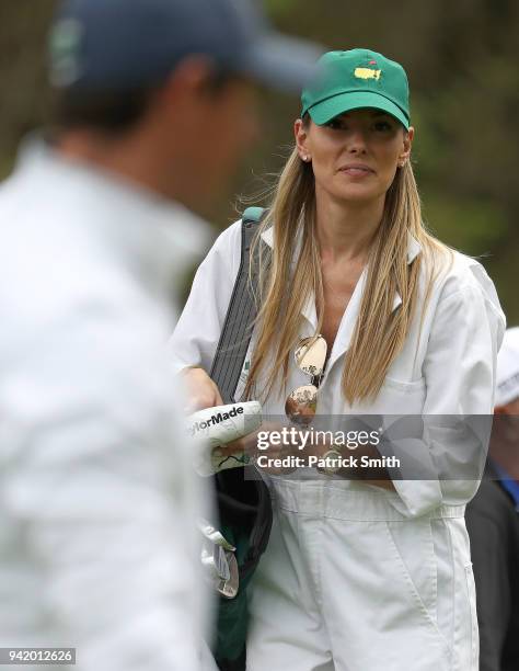 Erica Stoll, wife of Rory McIlroy of Northern Ireland, looks on during the Par 3 Contest prior to the start of the 2018 Masters Tournament at Augusta...
