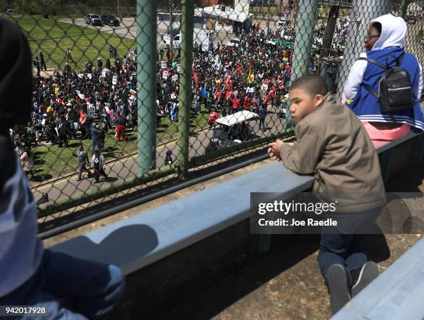 People watch as marchers pass-by during an event to mark the 50th anniversary of Dr. Martin Luther King Jr.'s assassination April 4, 2018 in Memphis,...