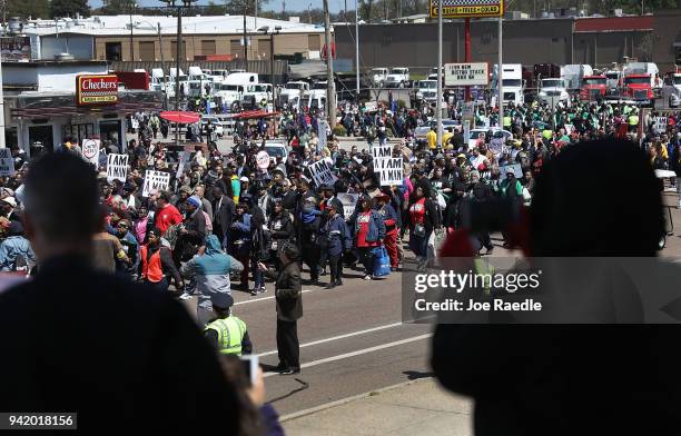 People watch as marchers pass-by during an event to mark the 50th anniversary of Dr. Martin Luther King Jr.'s assassination April 4, 2018 in Memphis,...