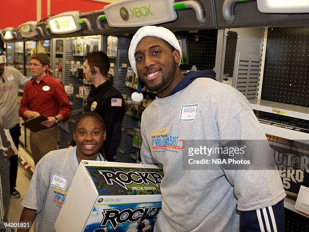 White along with players and coaches from the Oklahoma City Thunder host a shopping spree for low-income families at the City Super Target in...