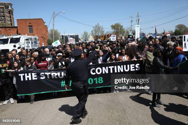 People gather together during an event to mark the 50th anniversary of Dr. Martin Luther King Jr.'s assassination April 4, 2018 in Memphis,...