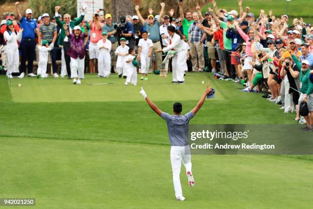 Tony Finau of the United States rolls his ankle as he celebrates his hole-in-one on the seventh hole during the Par 3 Contest prior to the start of...