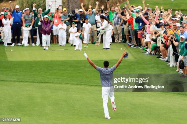 Tony Finau of the United States rolls his ankle as he celebrates his hole-in-one on the seventh hole during the Par 3 Contest prior to the start of...