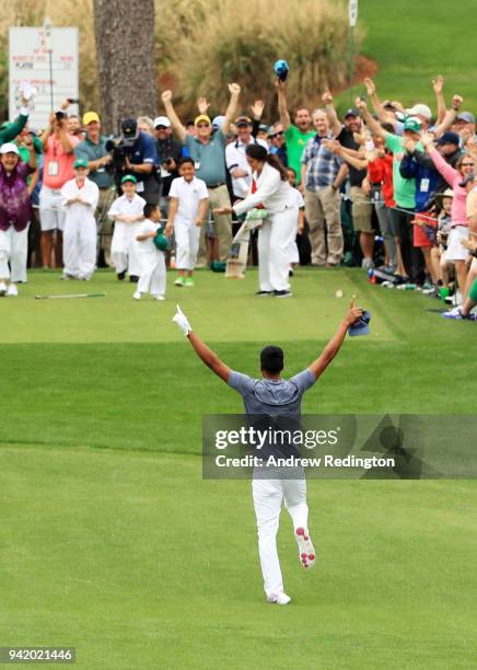 Tony Finau of the United States rolls his ankle as he celebrates his hole-in-one on the seventh hole during the Par 3 Contest prior to the start of...