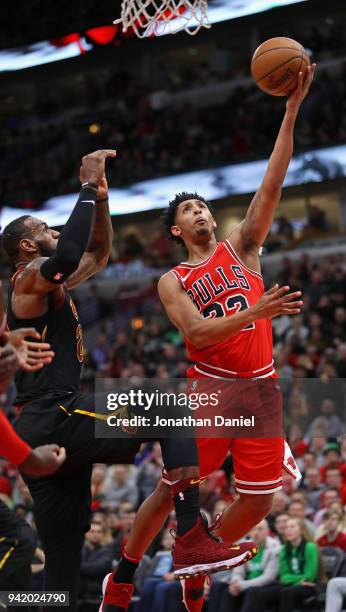 Cameron Payne of the Chicago Bullsputs up a shot against LeBron James of the Cleveland Cavaliers at the United Center on March 17, 2018 in Chicago,...