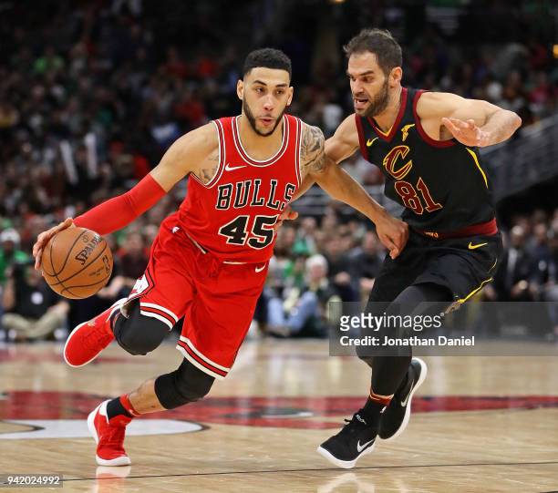 Denzel Valentine of the Chicago Bulls drives past Jose Calderon of the Cleveland Cavaliers at the United Center on March 17, 2018 in Chicago,...